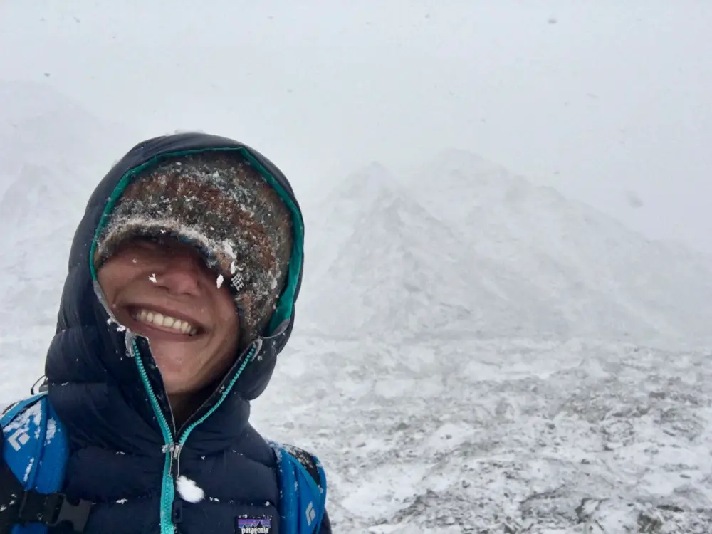 Dangers while trekking in Nepal - bad weather. Heavy snow but smiling.